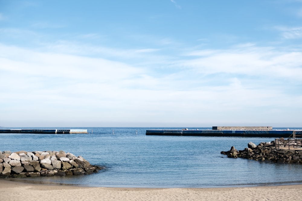 a body of water sitting next to a sandy beach