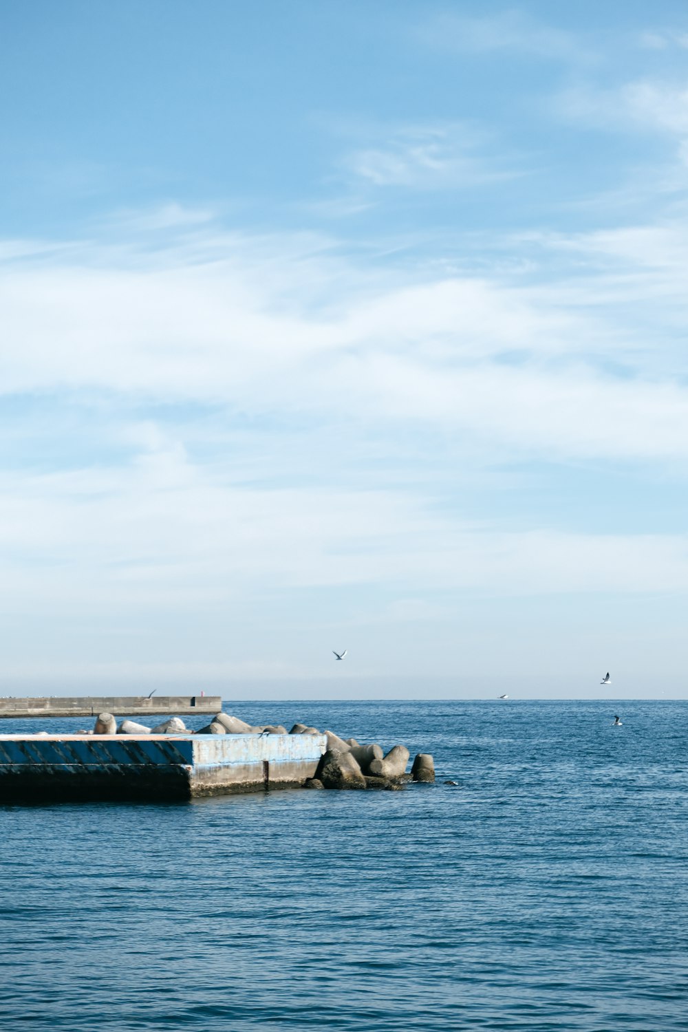 a large body of water with a boat in the distance