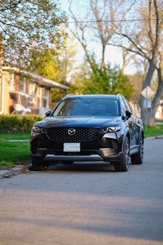 A sleek SUV parked outside a suburban home, ready for a long trip.