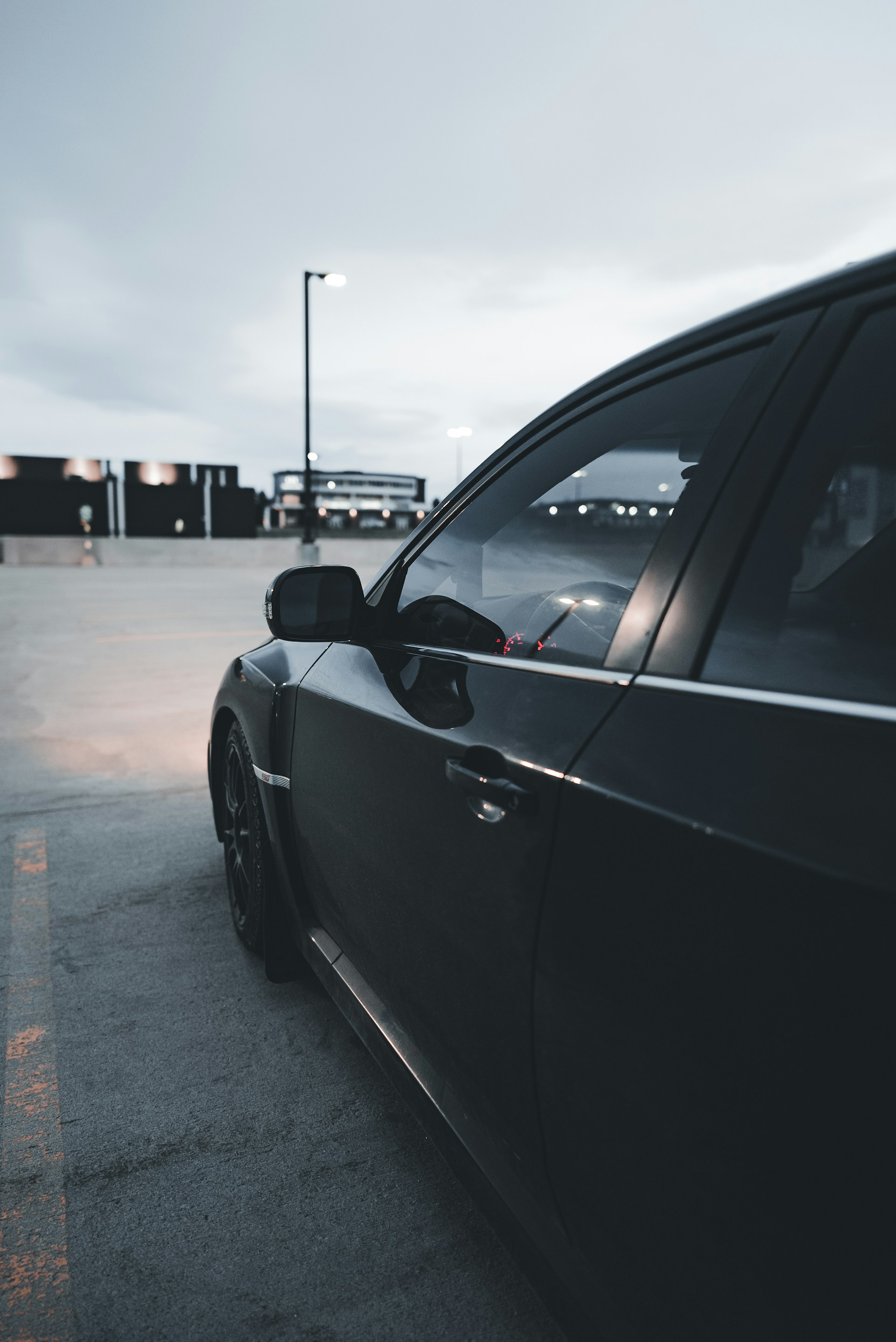 a black car parked in a parking lot