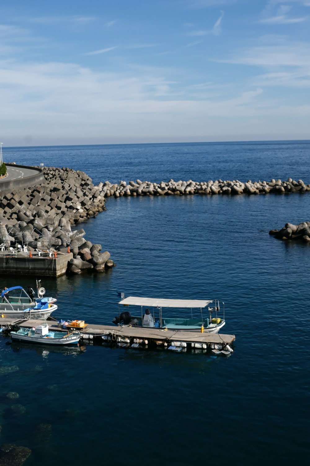 several boats are docked at a pier in the water