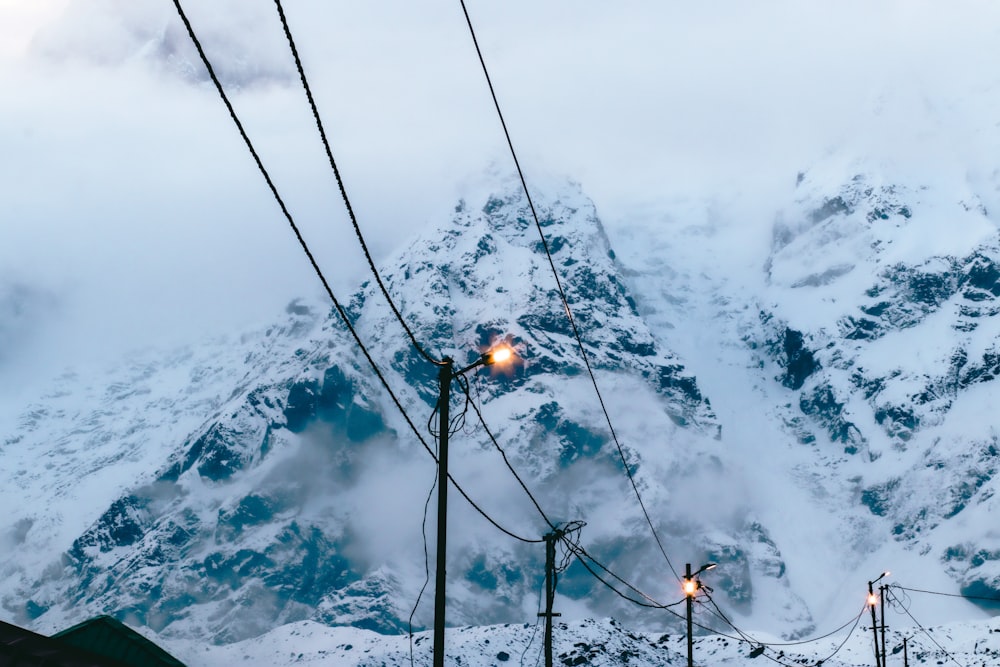 a mountain covered in snow with street lights