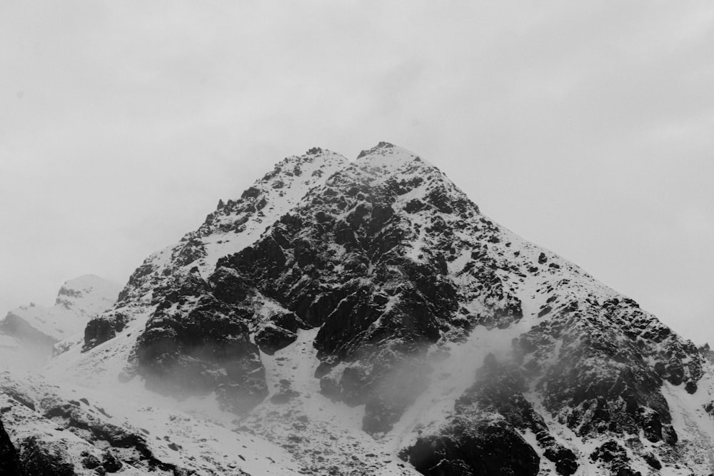 a mountain covered in snow with a sky background