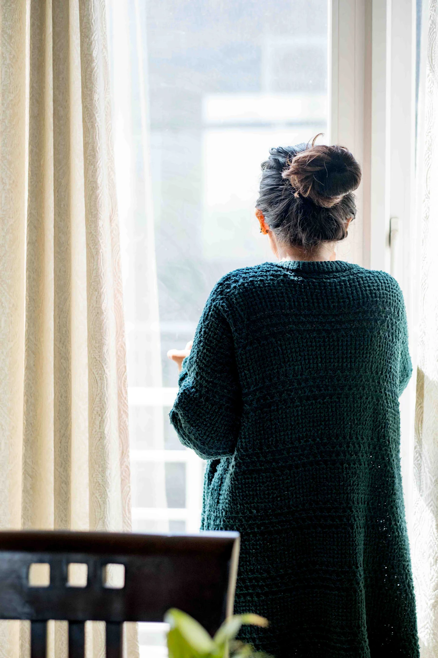 A woman at ease in soft natural light, a quiet held moment