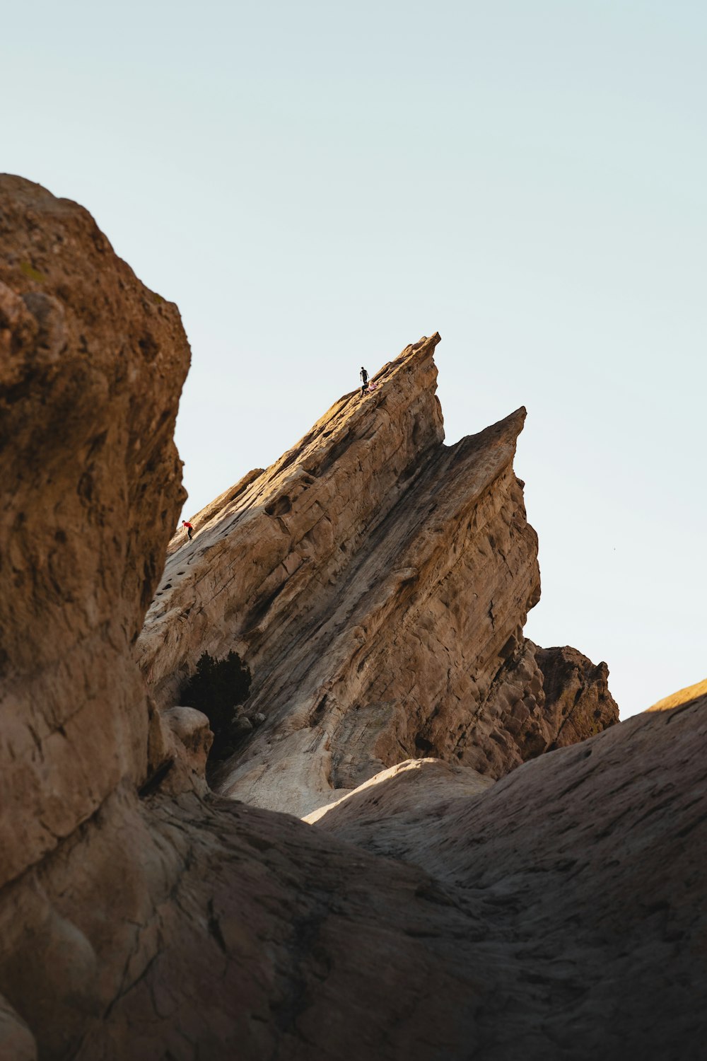 a person standing on top of a large rock