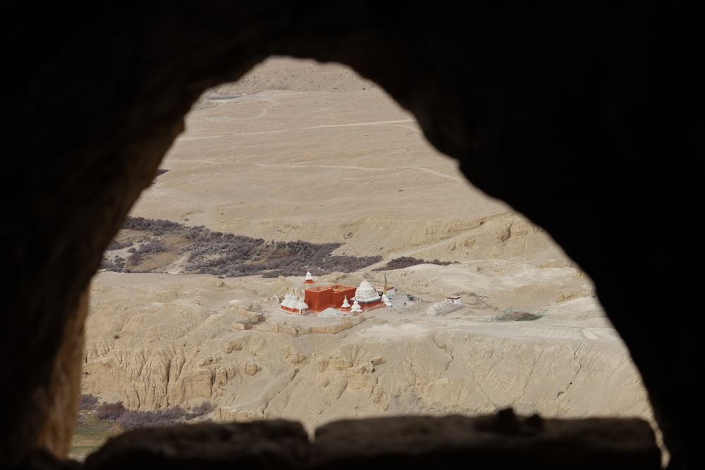 a view of a small building through a cave