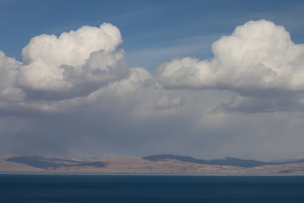 a large body of water under a cloudy sky