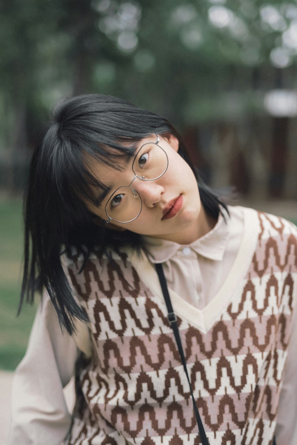 a woman with glasses is posing for a picture