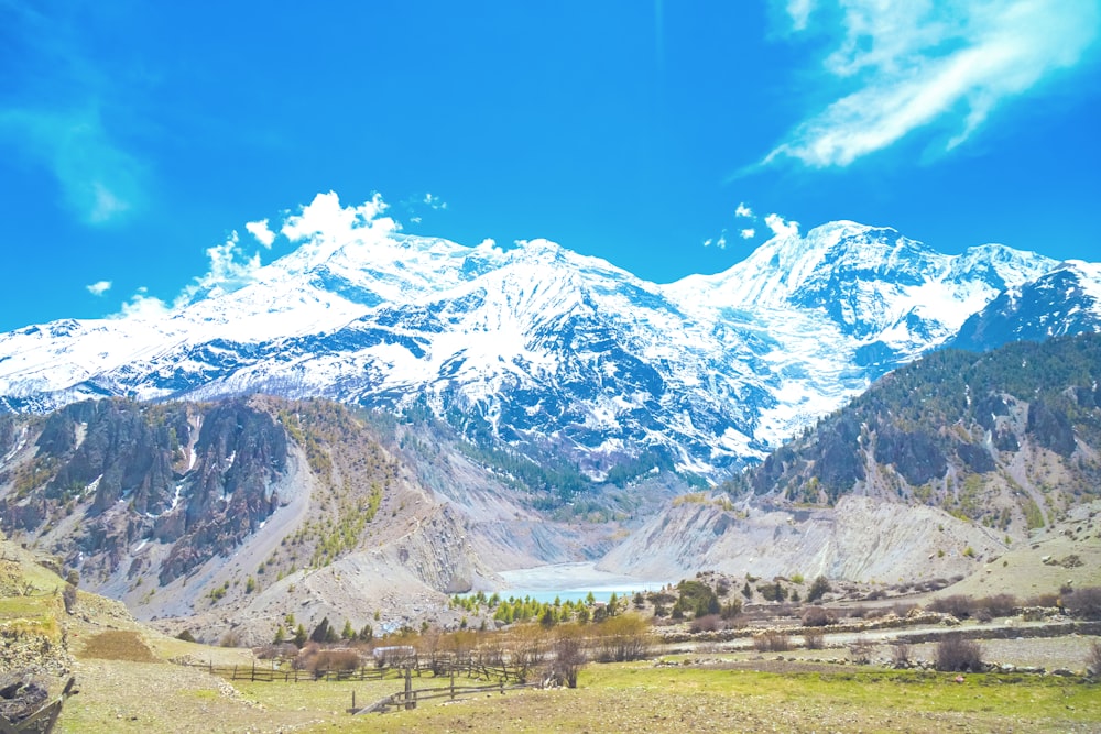 a view of a mountain range with a lake in the foreground