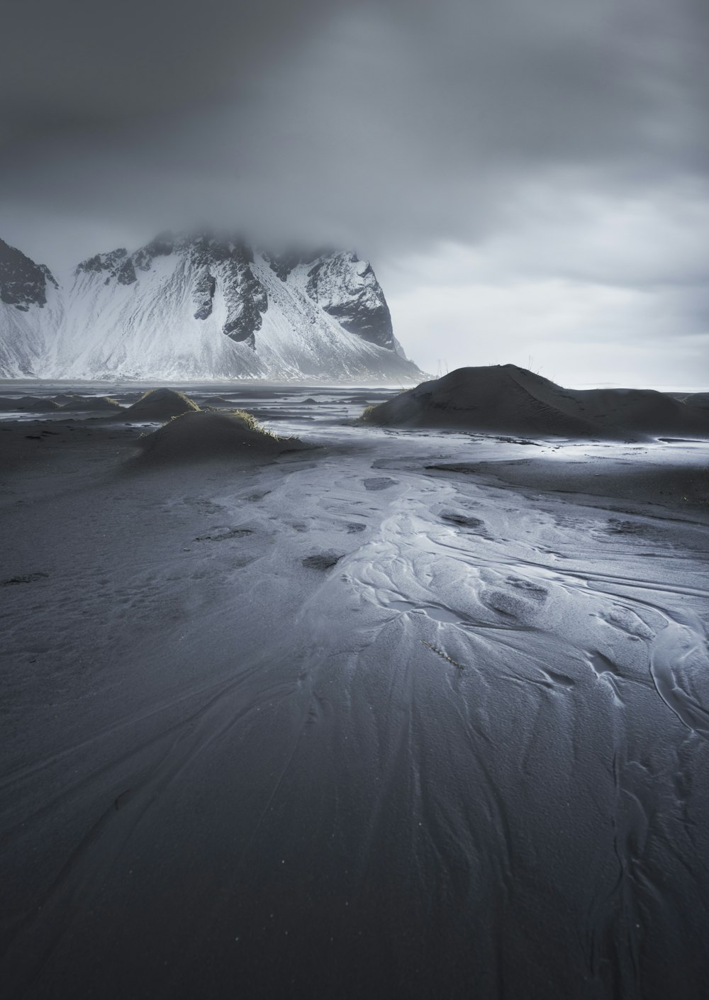 a black and white photo of snow covered mountains