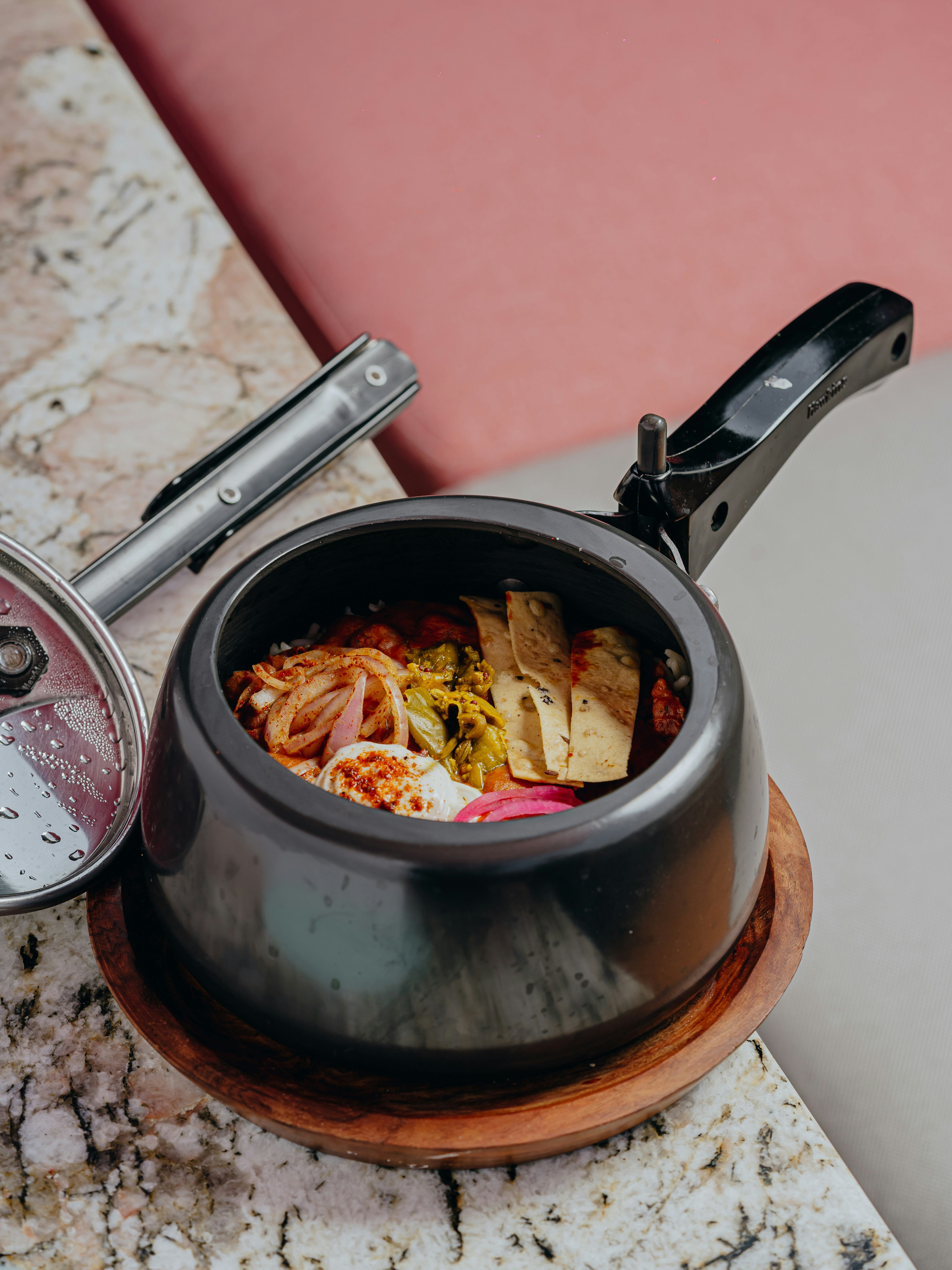 a bowl of food sitting on top of a counter next to a cell phone