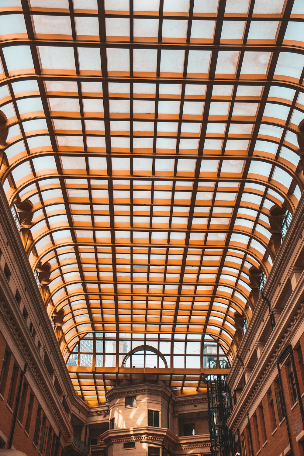 the inside of a building with a large metal roof