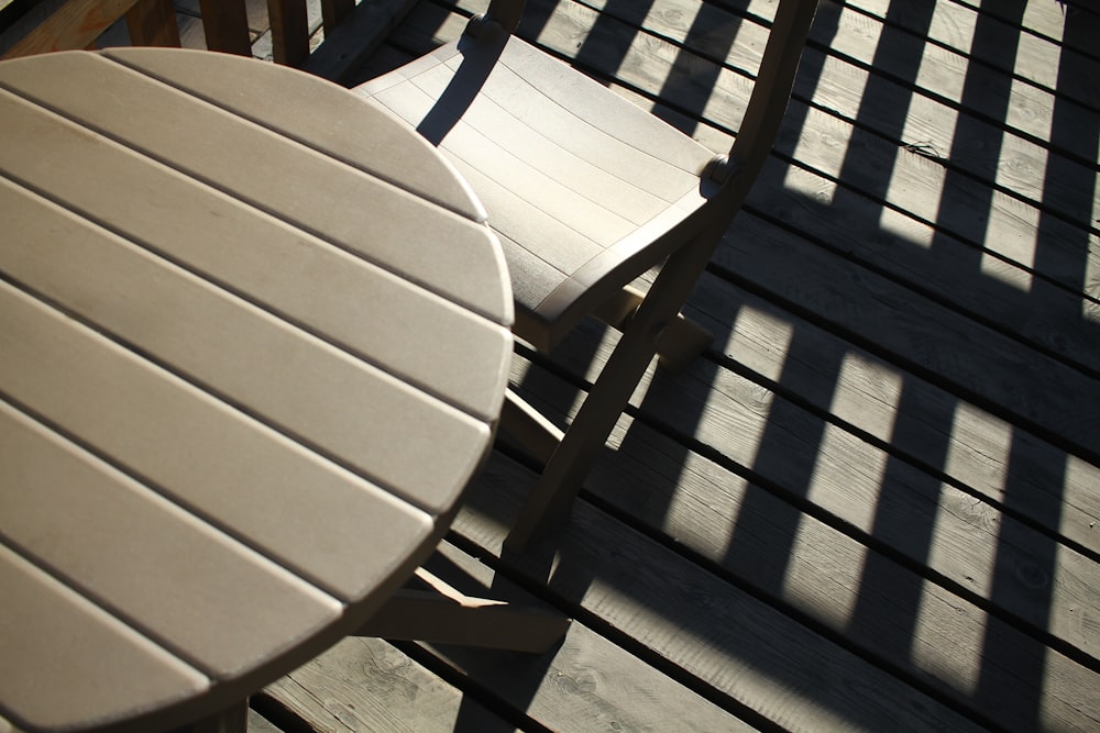 a table and two chairs on a wooden deck