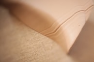 A close-up of soft fabric textures in neutral tones.