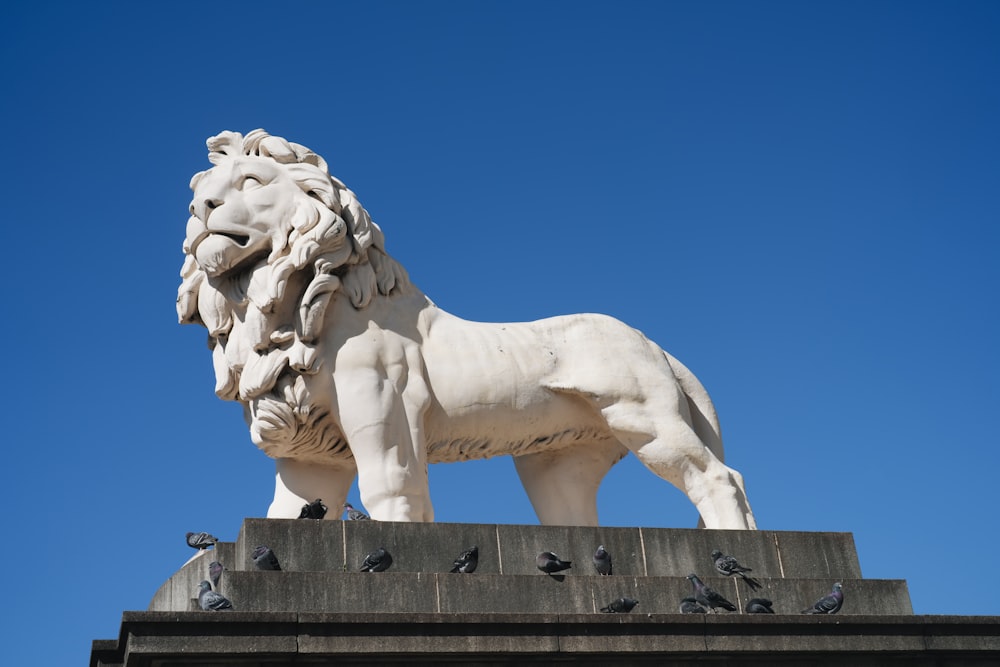 a statue of a lion on top of a building