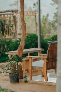 A beautifully designed outdoor seating area featuring custom wooden furniture and lush greenery.