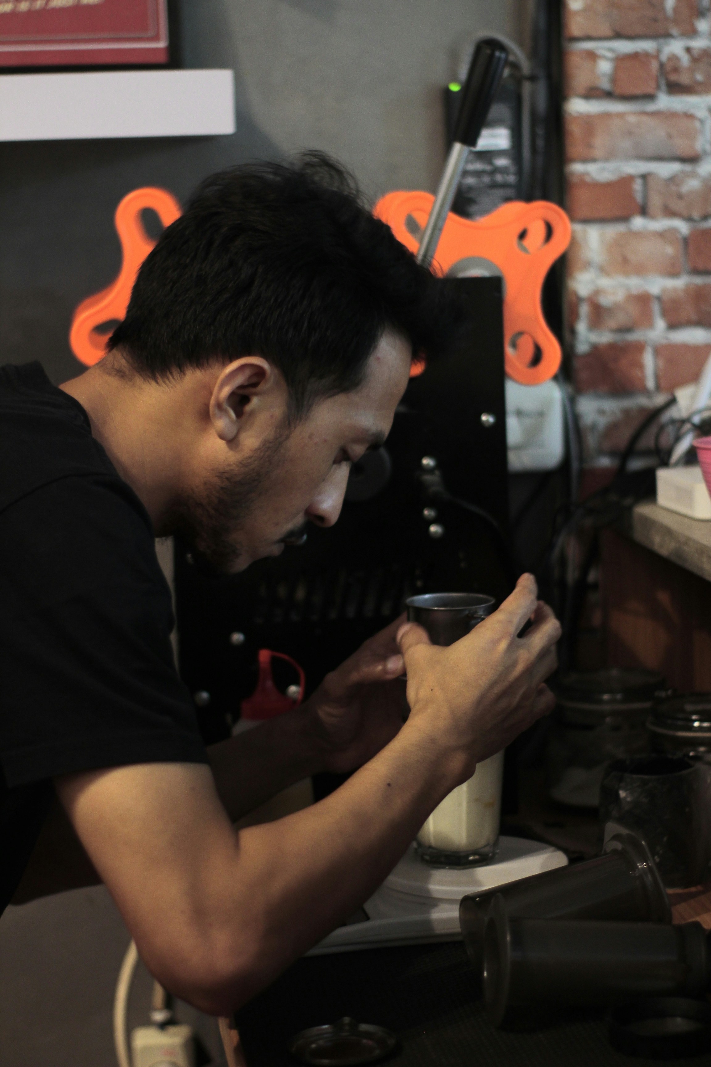 a man sitting at a table using a cell phone