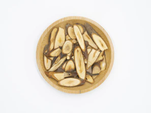 Close-up of vibrant maca root powder in a rustic wooden bowl.