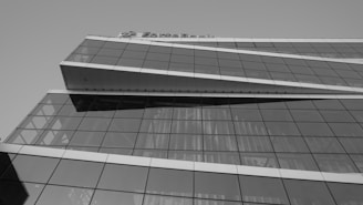 Street view of a contemporary commercial building with glass facade and signage space.
