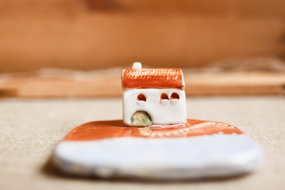 a small toy house sitting on top of a table