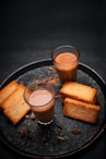 a plate of food that includes bread and drinks