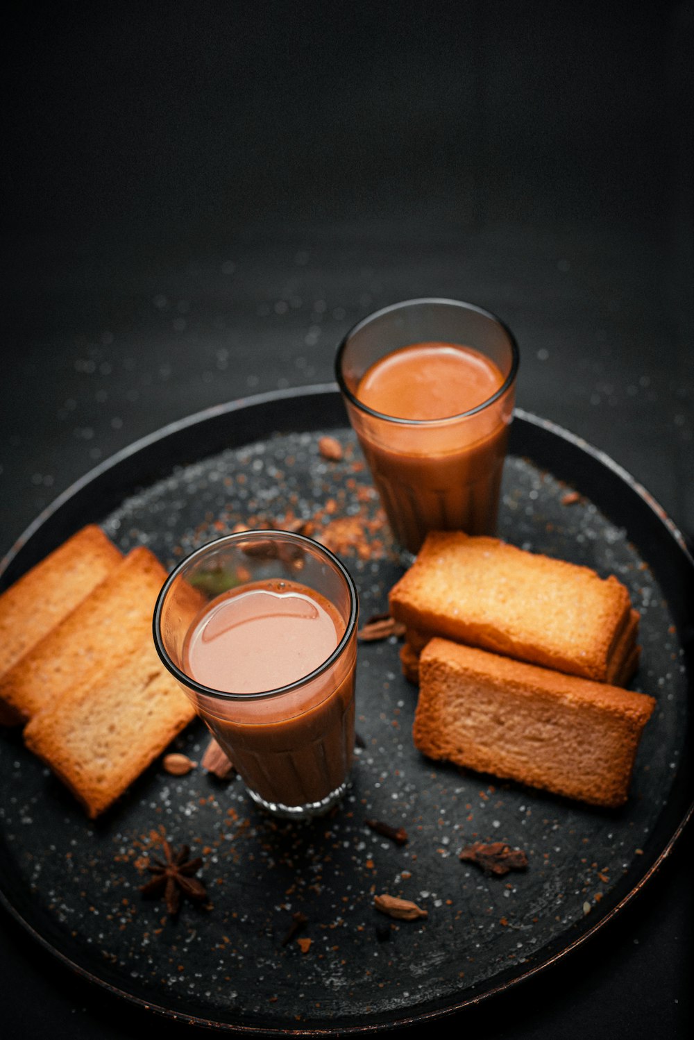 a plate of food that includes bread and drinks