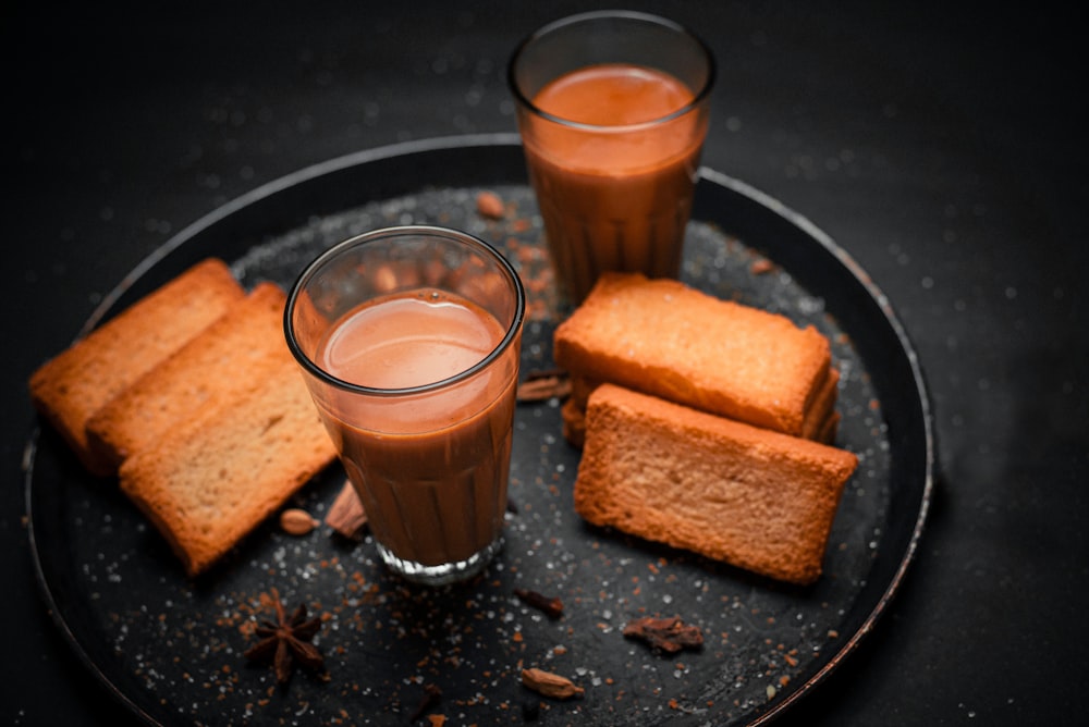 a plate of food that includes bread and a drink