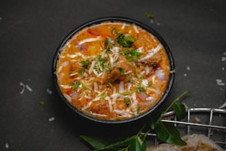 a bowl of food with meat and cheese