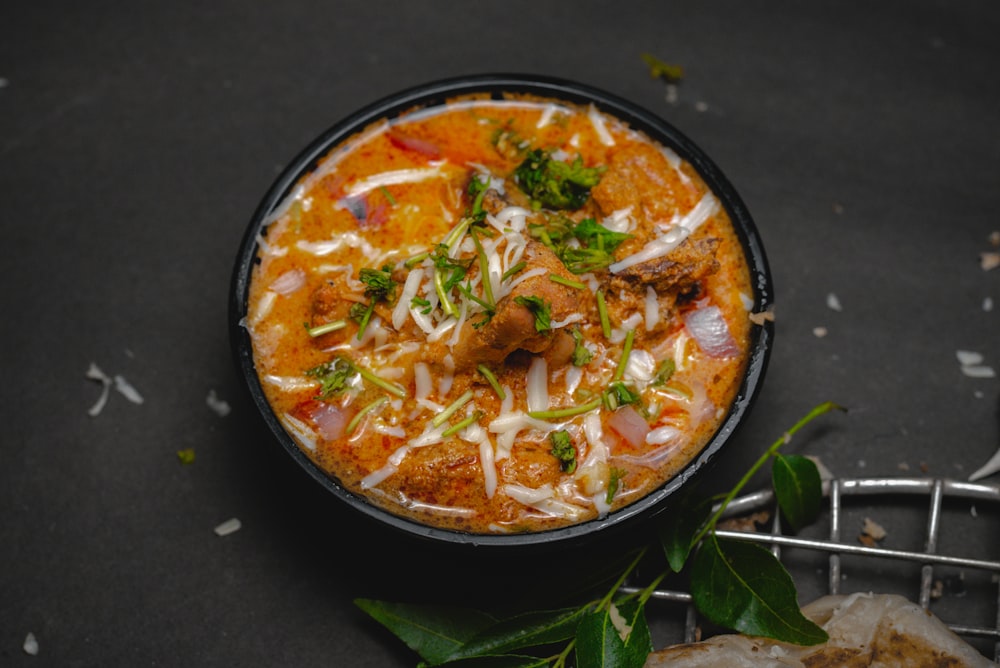 a bowl of food with meat and cheese