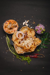 a plate of food on a black surface