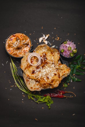 a plate of food on a black surface