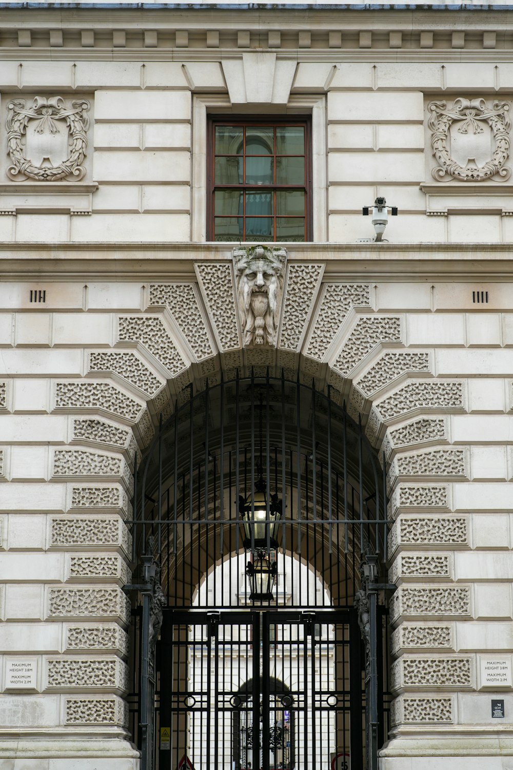 a gated entrance to a building with a clock on it