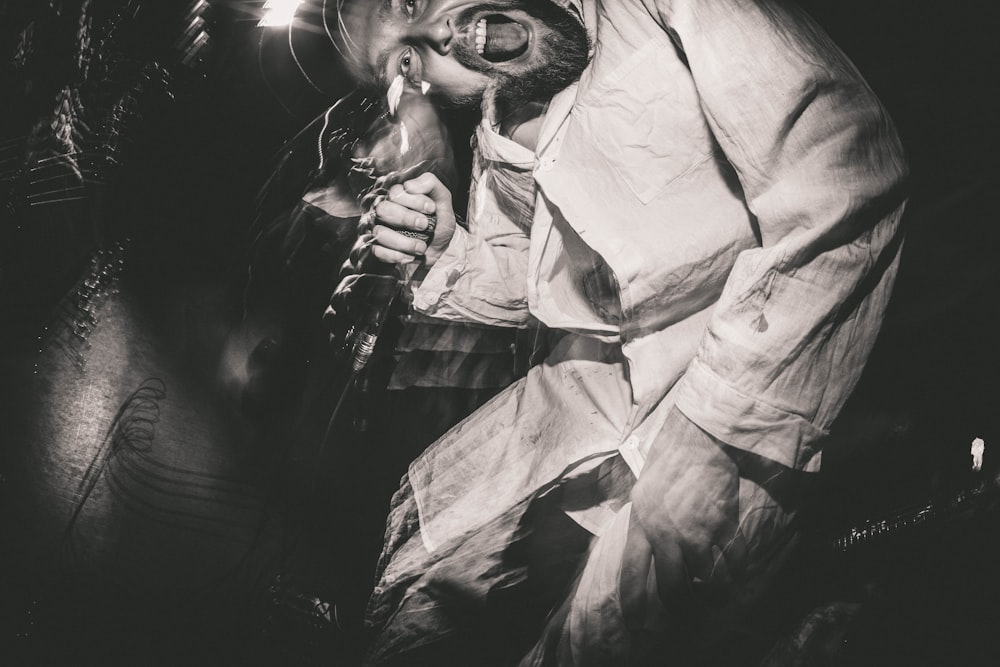 a black and white photo of a man smoking a cigarette