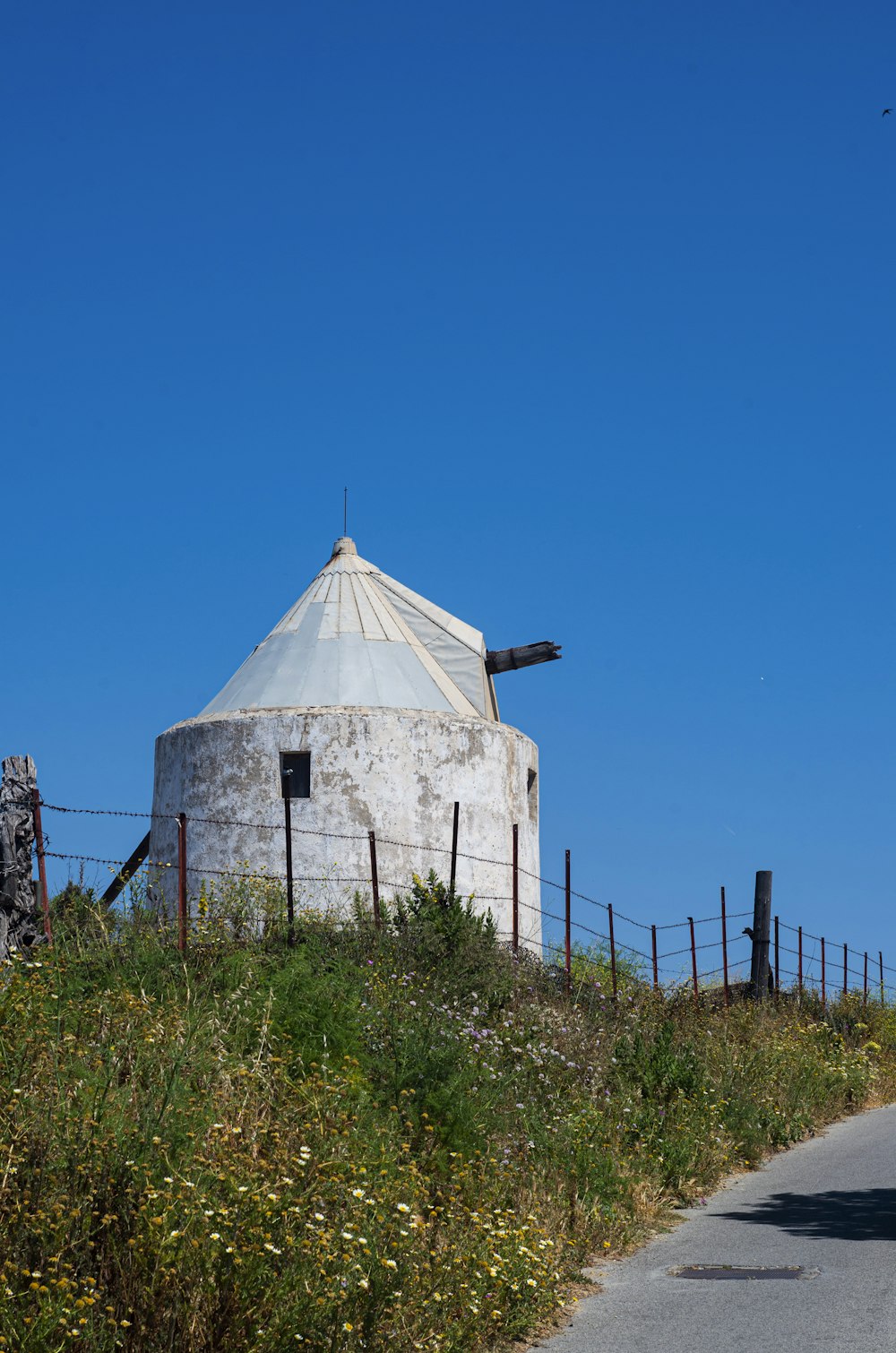 a large white building sitting on the side of a road