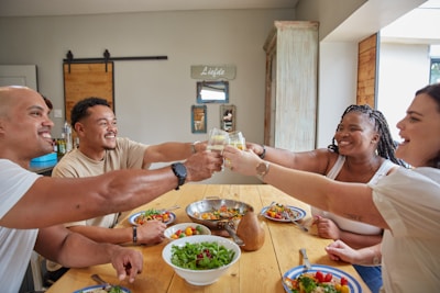 a group of people sitting around a wooden table