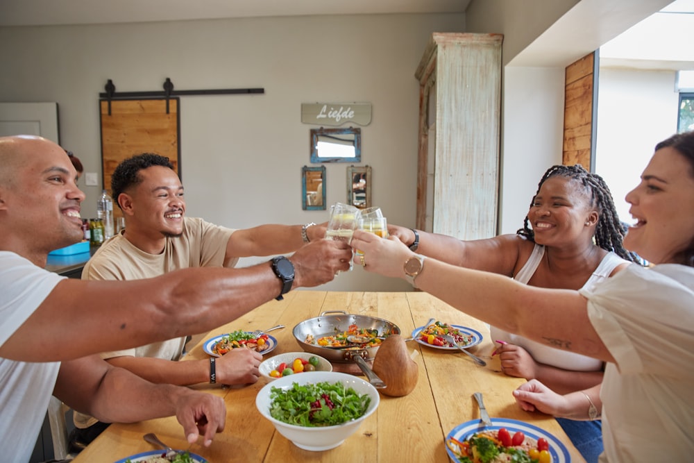 a group of people sitting around a wooden table