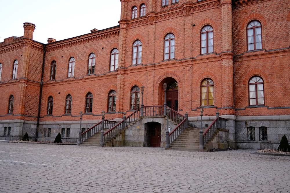 a large brick building with stairs leading up to it
