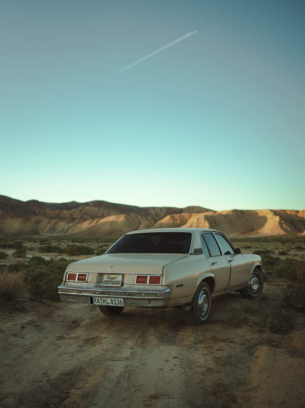 a car parked on a dirt road in the desert