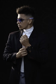 A man adjusting his watch in front of a mirror, showcasing confidence.