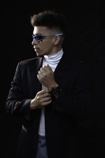 A man adjusting his watch in front of a mirror, showcasing confidence.