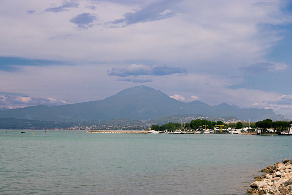 a body of water with a mountain in the background