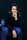 a woman sitting in a chair with her hand on her chin