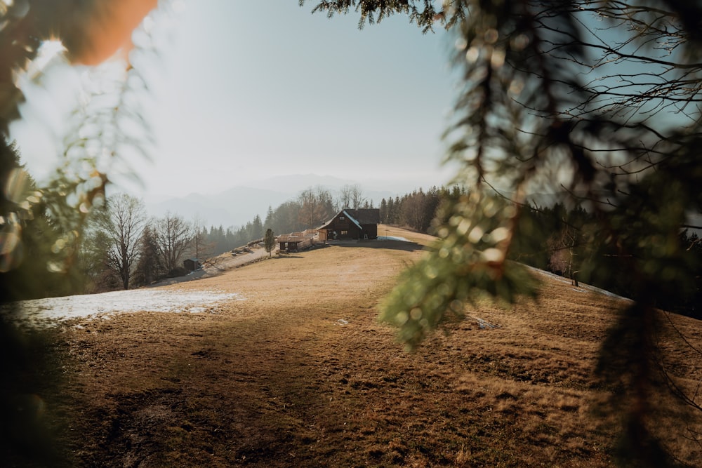 a house in the middle of a snowy field