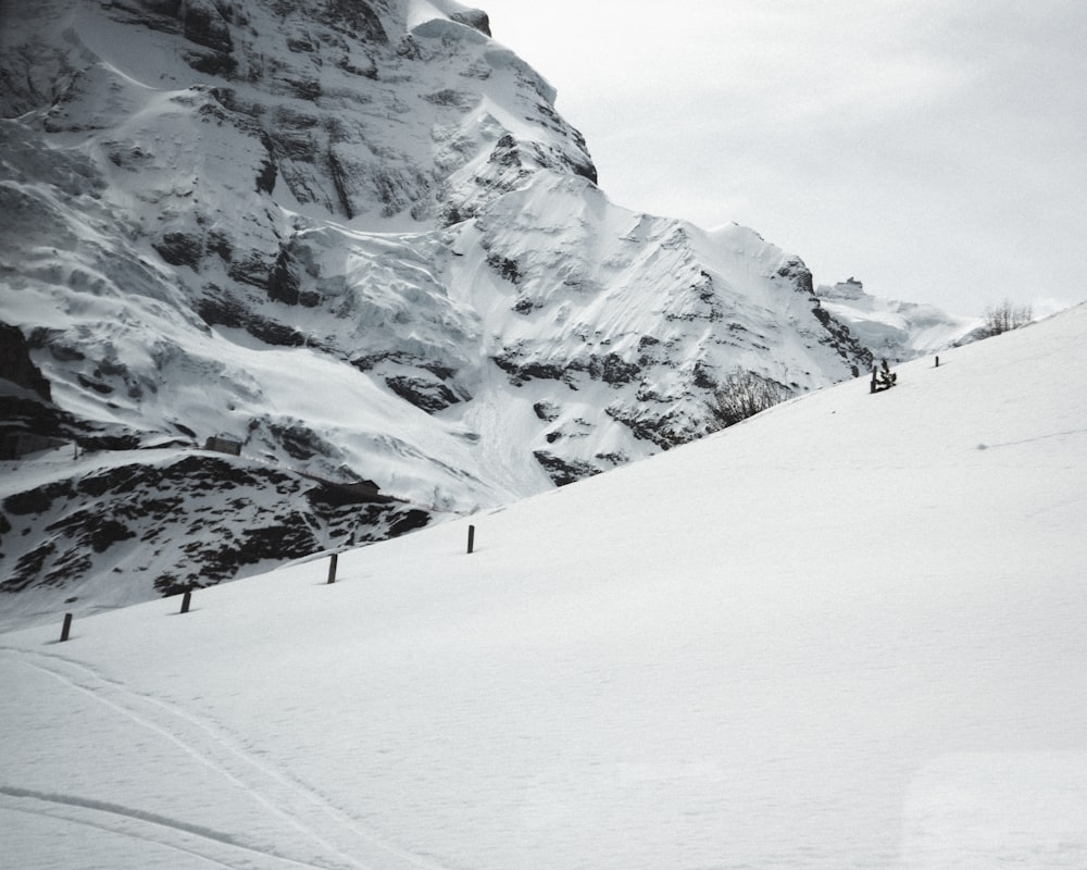 a man riding skis down a snow covered slope