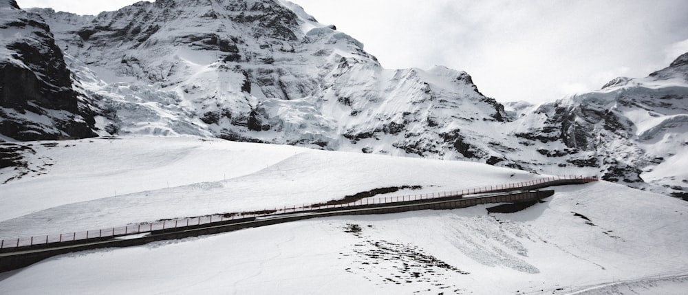 a train traveling through a snow covered mountain range