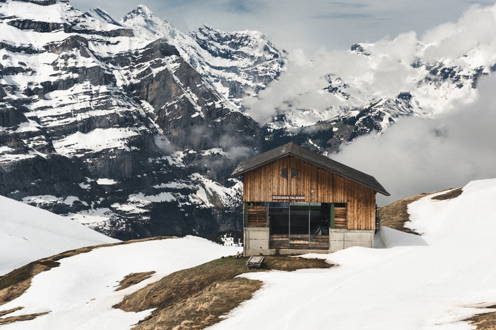 a small building on top of a snow covered mountain