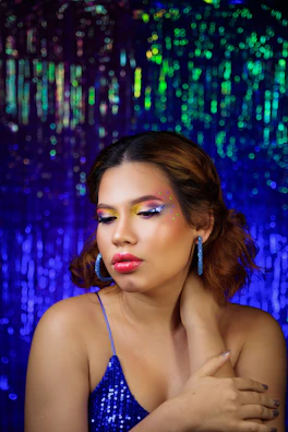 Glamorous evening makeup with shimmering eyeshadow and bold lipstick on a confident model.