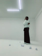 A simple sketch of a person pausing thoughtfully in a minimalist workspace.