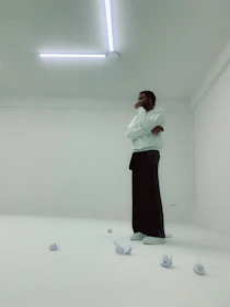 A simple sketch of a person pausing thoughtfully in a minimalist workspace.