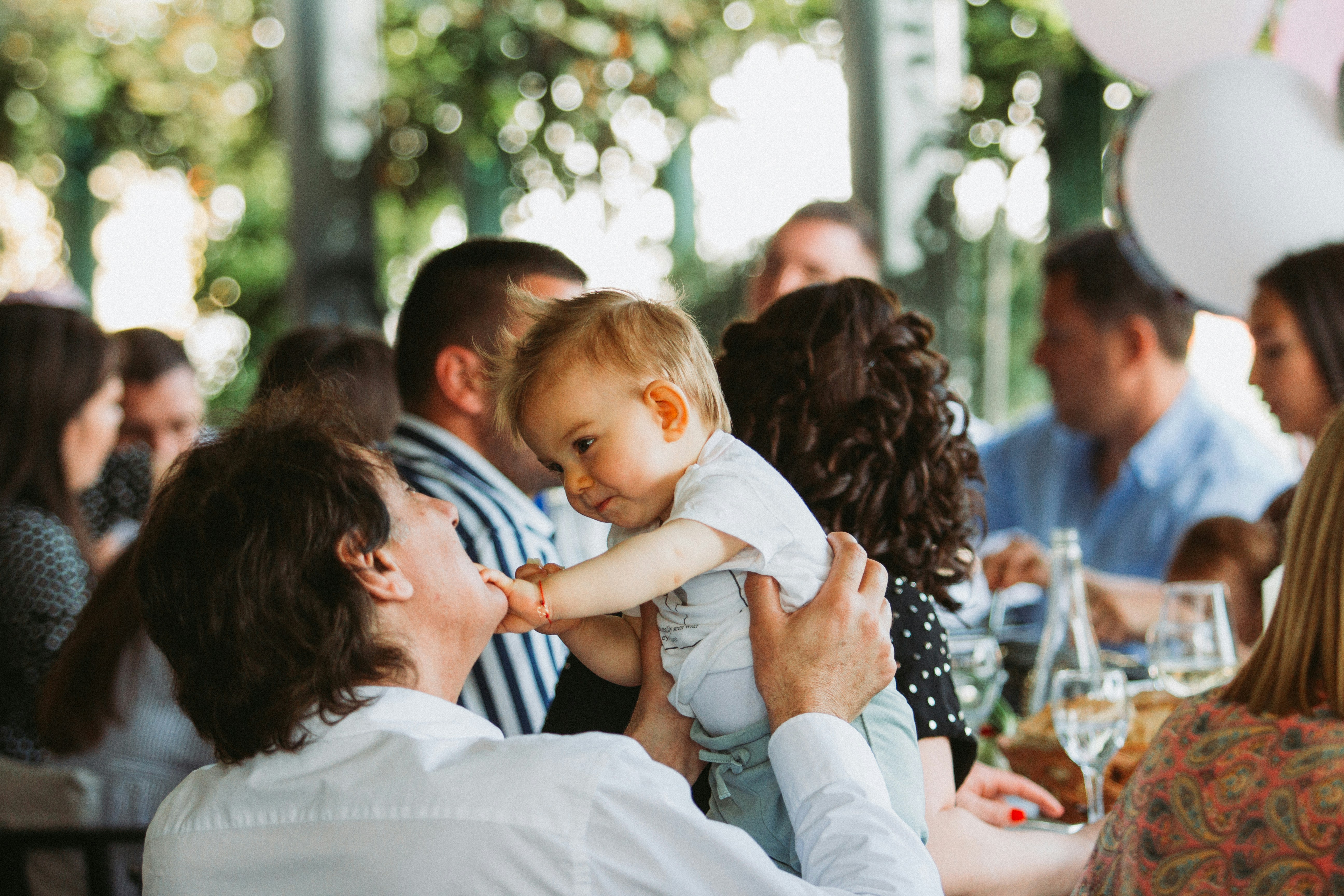 A woman holding a baby at a party